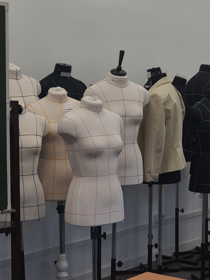Dress forms marked with pattern lines in a sewing studio